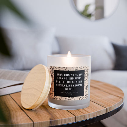 Candle with a decorative label on a wooden table