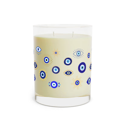 Candle with evil eye pattern on a beige label against a white background