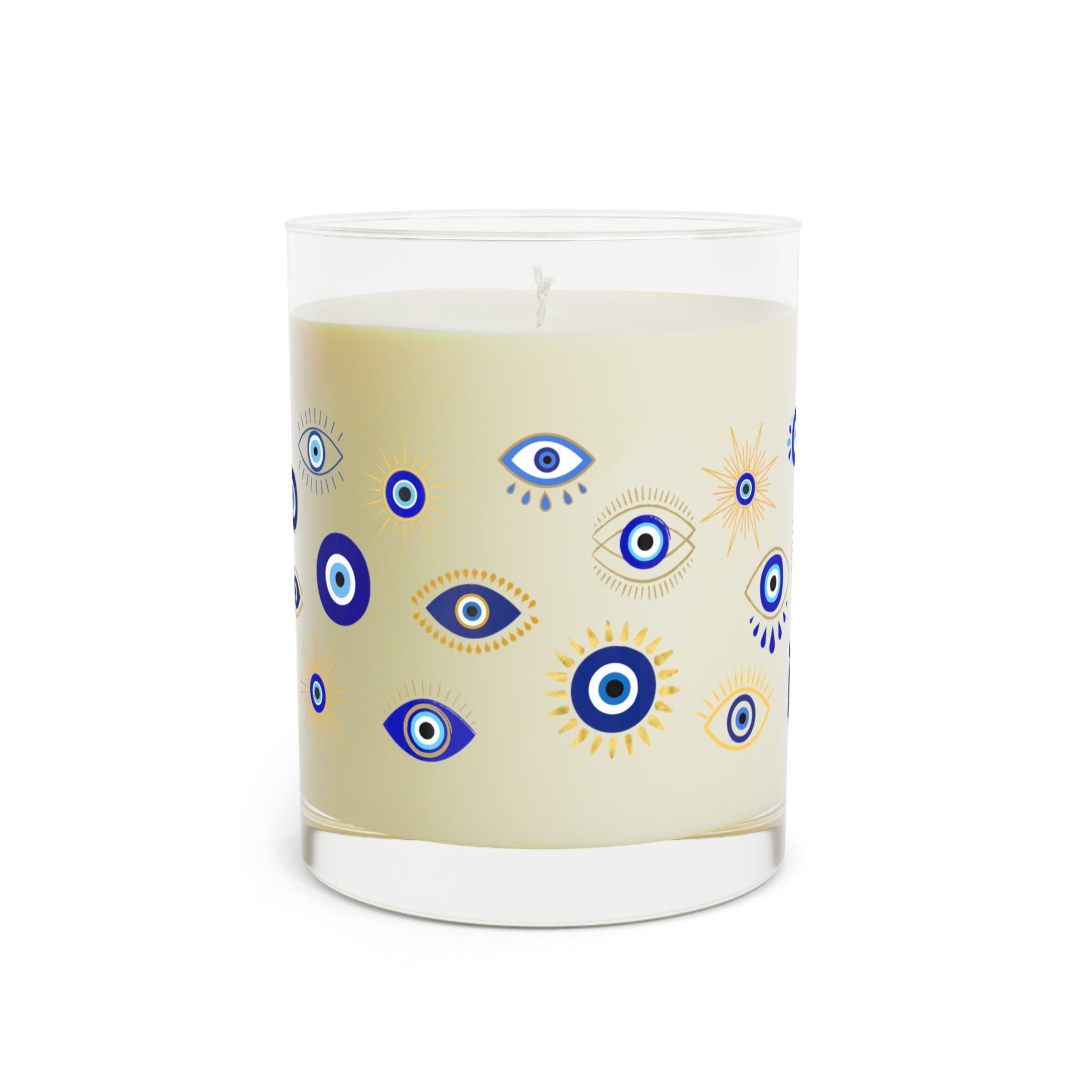 Candle with evil eye pattern on a beige background