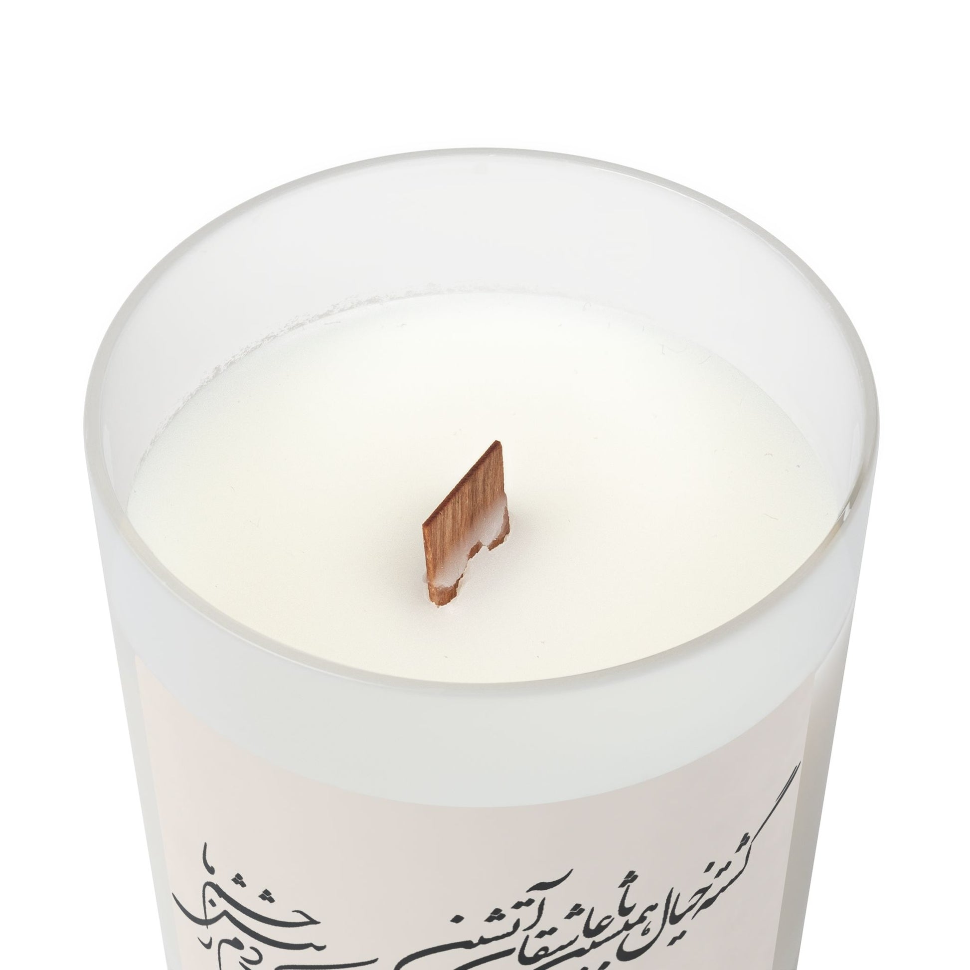 White candle with farsi text on a white background