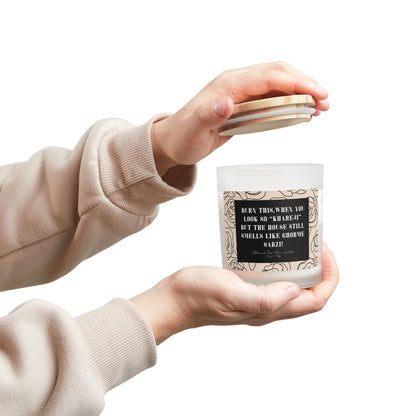 Person holding a candle with a humorous label on a white background