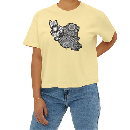 Woman wearing a light yellow t-shirt with a black and white Iran map design on a beige background