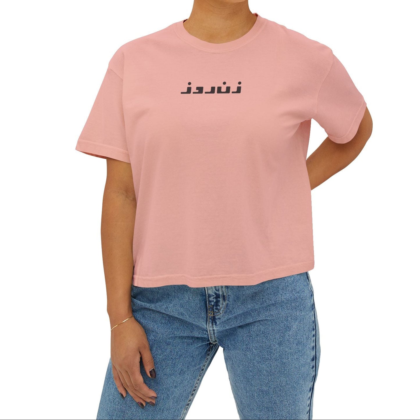 Person wearing a pink t-shirt with a decorative design on a white background