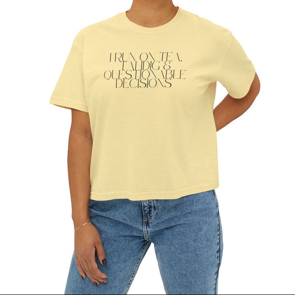 Person wearing a yellow t-shirt with I run on tea, tahdig & questionable decisions text on the chest. 