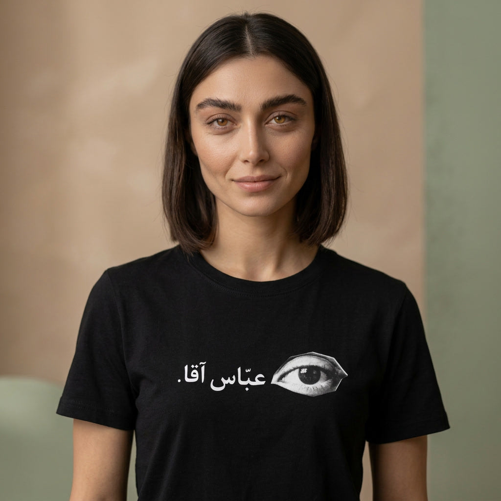 woman wearing a black tshirt with farsi text on the chest. 