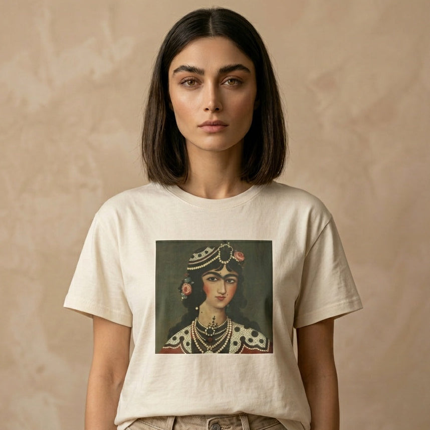 Person wearing a beige t-shirt with a graphic of a Qajar woman's portrait on the chest on a beige background