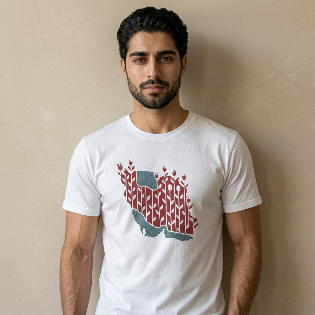 Man wearing a white t-shirt with a graphic design of Iran's map against a beige wall