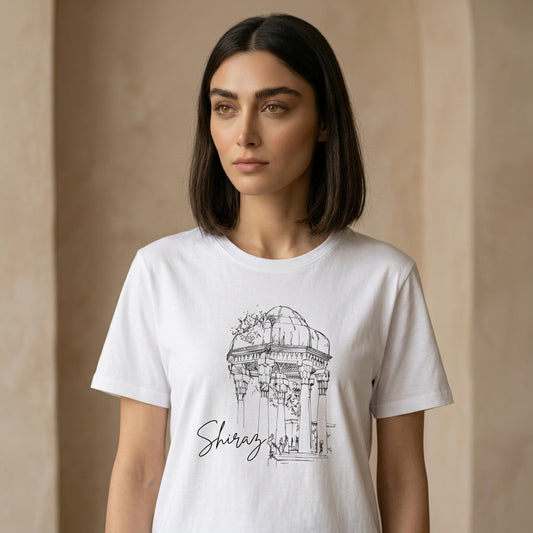 Woman wearing a white t-shirt with a black architectural design of Hafez Tomb and 'Shiraz' text on a beige background