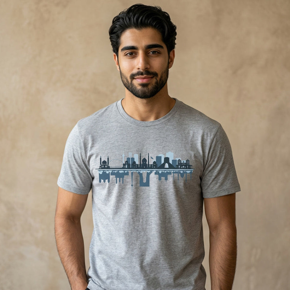 Man wearing a gray t-shirt with a graphic of the Tehran skyline design on a beige background