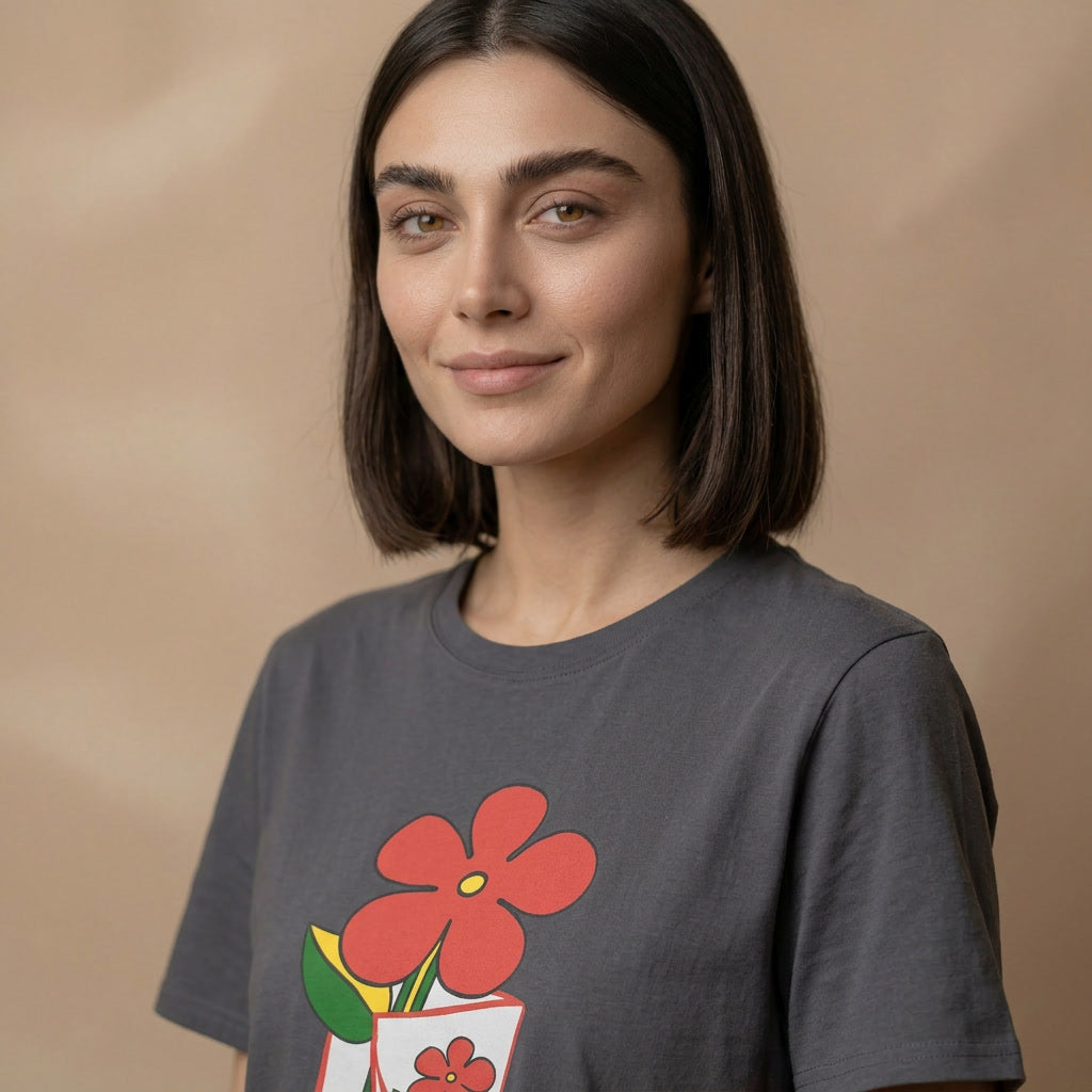 Woman wearing a dark gray t-shirt with a red floral design on a beige background