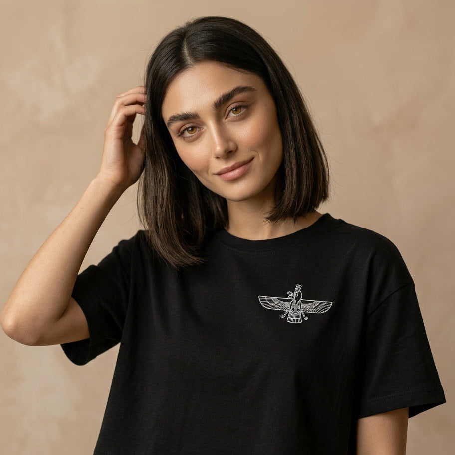Woman wearing a black t-shirt with a white Farvahar sign on its chest on a beige background 