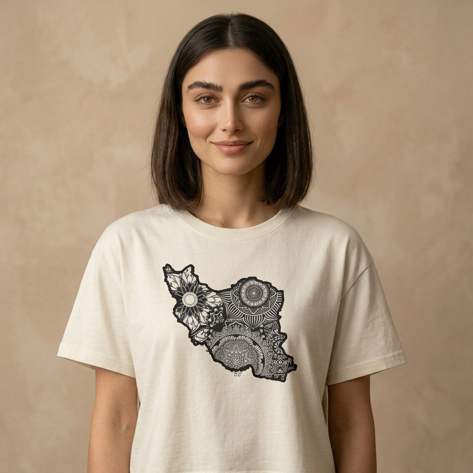 Woman wearing a beige t-shirt with a black Iran map design on a beige background