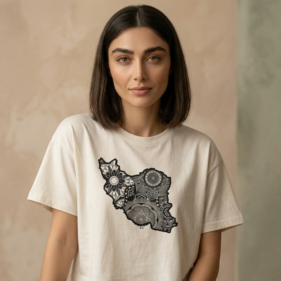 Woman wearing a beige t-shirt with a black and white Iran map design on a beige background